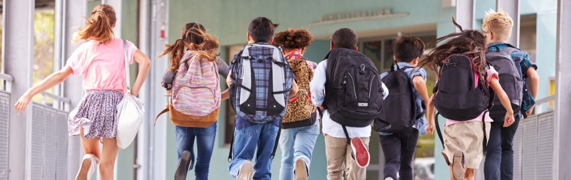 Two ways to exempt a backpack in Connecticut — Wacky Tax Wednesday Group of students wearing backpacks and running toward school.