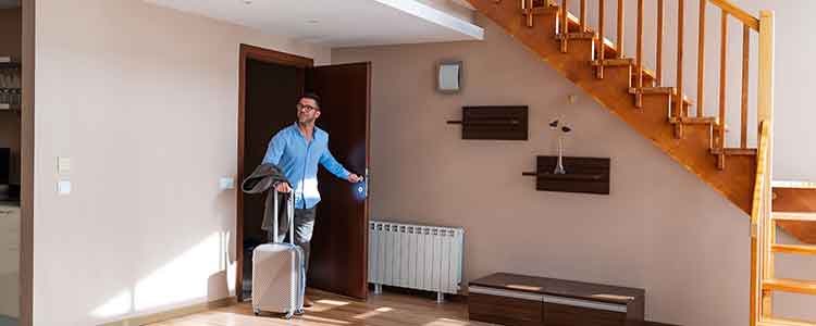 guest with luggage enters short-term rental