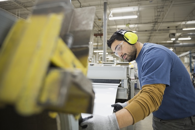 Worker in sheet metal factory