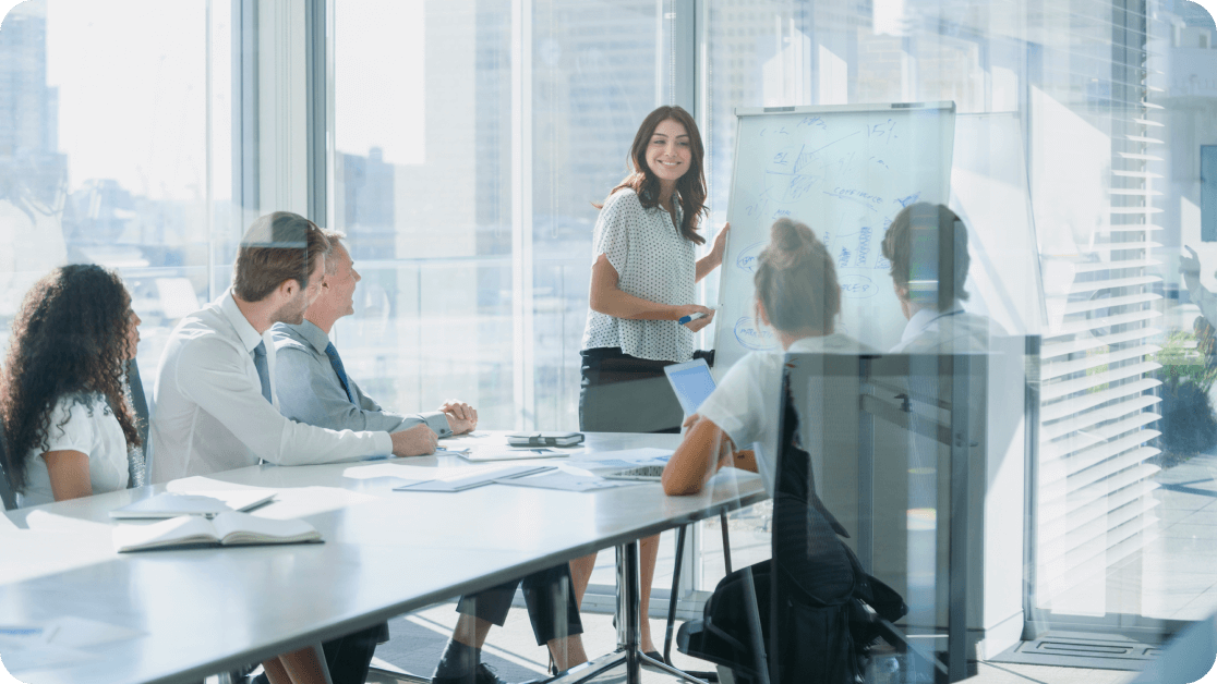 Group of professionals working together in a high-rise conference room.
